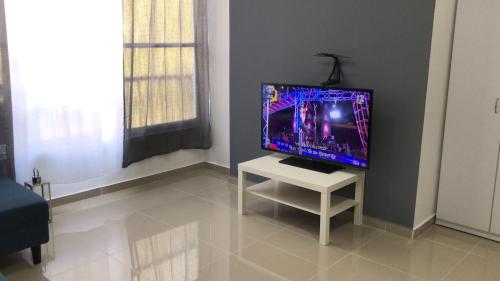 a television sitting on a table in a room at Isramax apartment near the beach. in Bat Yam