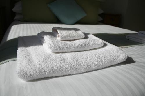 two towels sitting on top of a bed at Gowan Bank in Gourdon