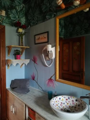 a bathroom with a sink and a mirror at El Mirador del Gato I y II in Mesegar de Corneja