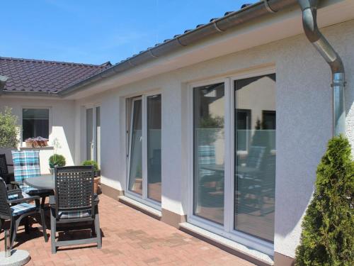 a patio with sliding glass doors on a house at Ferienhaus Schlossblick an der Ostsee - ABC236 in Zierow