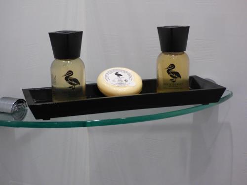 two bottles of soap sitting on a glass shelf at Whitehaven Guest House in Whitby