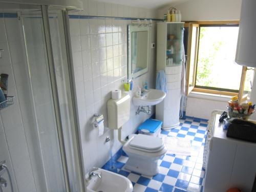 a bathroom with a toilet and two sinks and a shower at Villa Bella in Grožnjan
