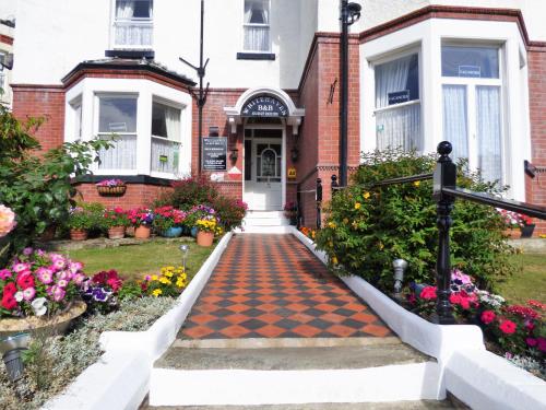 a house with a checkered walkway in front at Whitehaven Guest House in Whitby