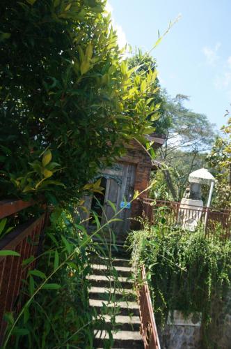 a set of stairs leading up to a house at Manggis Garden Dive Resort in Candidasa