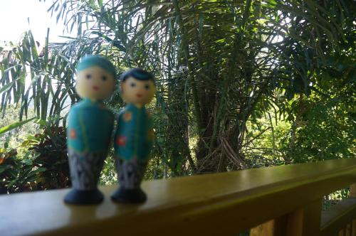 two toy figurines sitting on a wooden bench at Manggis Garden Dive Resort in Candidasa