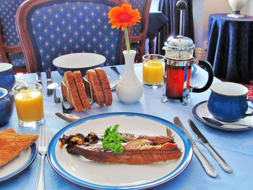 a table with a plate of food on a table at Whitehaven Guest House in Whitby