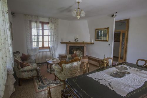 a living room with a bed and a fireplace at Villa Berra - Via Postale 63/A in Berra