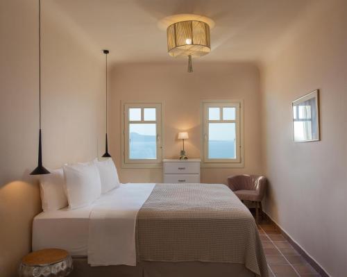 a bedroom with a bed and two windows at Villa Itis Luxury Suite with Balcony, Panoramic View & Jacuzzi in Neapoli Voion