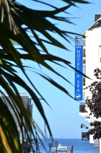 a sign for a hotel on the side of a building at Best Western Les Bains Hotel et SPA in Perros-Guirec