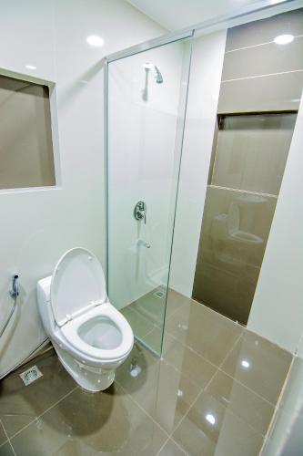 a bathroom with a toilet and a glass shower at Quest Villa in Panglao