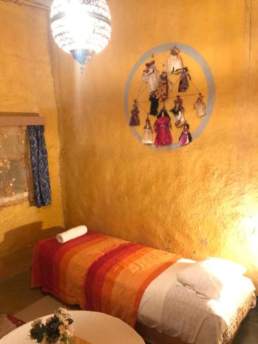 a room with a bed with a colorful blanket at Auberge Chez Julia in Merzouga