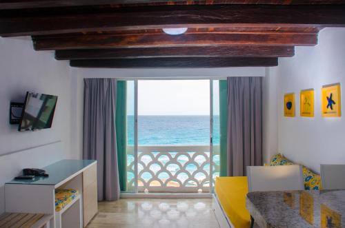 a living room with a view of the ocean at BSEA Cancun Plaza Hotel in Cancún