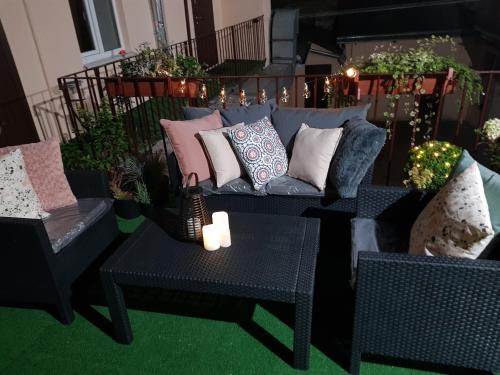 a living room with a couch and two tables and a candle at Apart-Hotel City Center Contrabas in Lviv