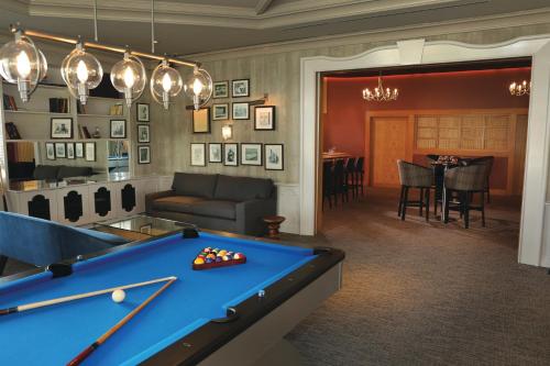 a billiard room with a pool table and a couch at Tropicana Atlantic City, A Caesars Destination in Atlantic City