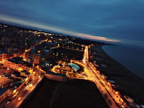 an aerial view of a city at night at b&b Tosches in Barletta