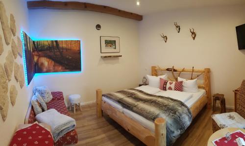 a bedroom with a bed and a chair at Naturtraum Georgshöhe in Thale