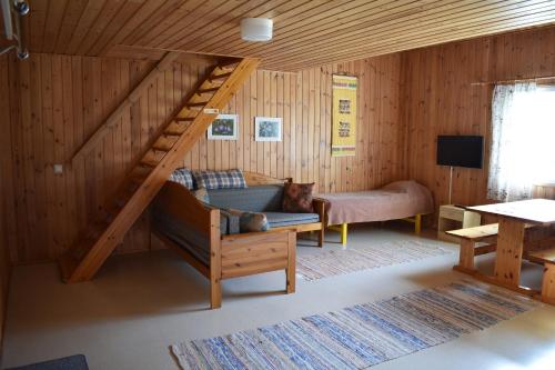 a living room with a loft bed and a couch at Karjalan Helmi in Tolosenmäki