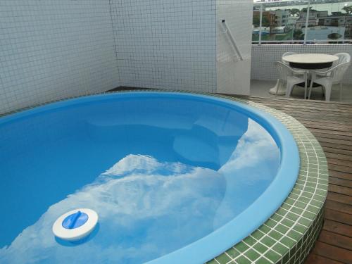 uma banheira azul com vista para uma montanha na água em Flat Jampa Cobertura Duplex A Beira Mar em João Pessoa