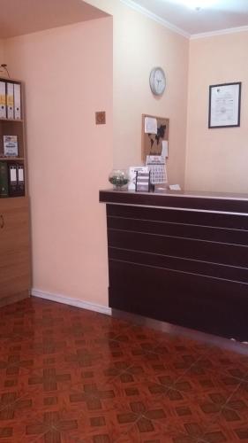 a law clerks office with a clock on the wall at Hotel Don Alfredo in Calama