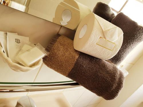 a stack of towels on a shelf in an open refrigerator at Hotel Marktbrauerei in Bad Lobenstein