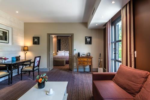 a living room with a couch and a table at La Chapelle Saint Martin in Nieul