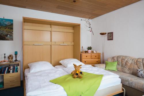 - un ours en peluche assis sur un lit dans une pièce dans l'établissement Ferienwohnung Harzblick, à Lautenthal
