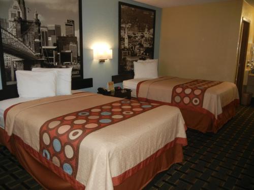 a hotel room with two beds in a room at Super 8 by Wyndham Cincinnati-Springdale OH in Springdale