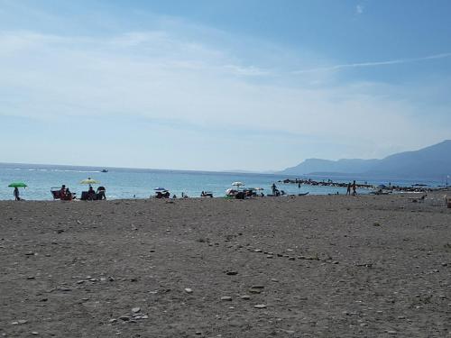 a group of people on a beach with umbrellas at Sandra Camporosso in Camporosso