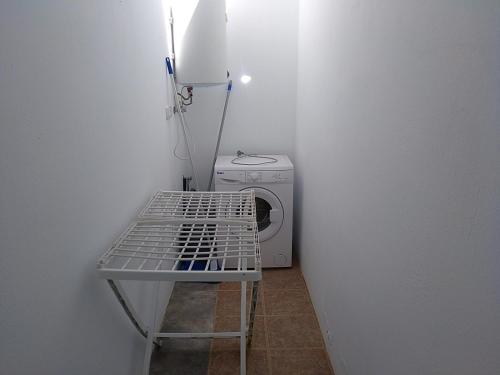 a small room with a washing machine and a washer at Quintero Suites in San Bartolomé