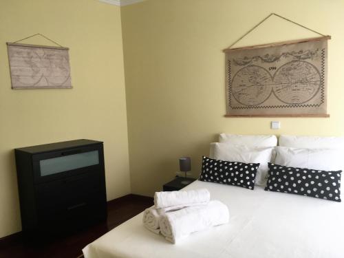 a bedroom with a bed with two towels on it at Mira Maia Apartment in Maia