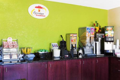 a kitchen with a counter top with food items on it at Super 8 by Wyndham Brunswick/St Simons Island Area in Brunswick