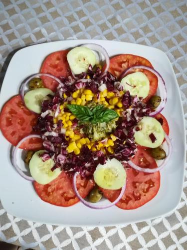 a plate of food with vegetables on a table at Agriturismo La Vallata in Masseria Scilva