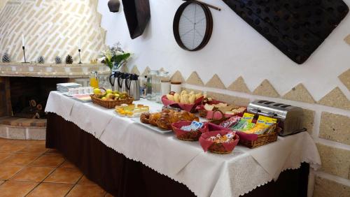 a table with a buffet of food on it at Hotel Rural Finca La Hacienda in Los Silos