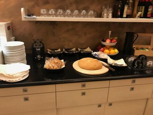 a kitchen counter with a plate of food on it at Hotel Nuova Orchidea in Dresano