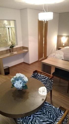 a living room with a table and a bed at Ives Hotel in Costa Rica