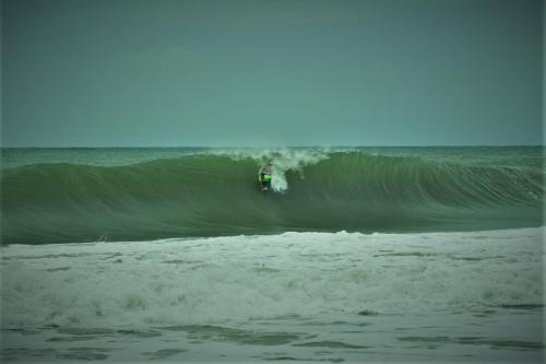 a person riding a wave on a surfboard in the ocean at Jungle Paunch in Bocas del Toro