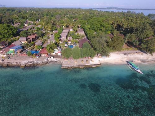 an aerial view of an island with a boat in the water at Sandy Beach Bungalows in Gili Islands