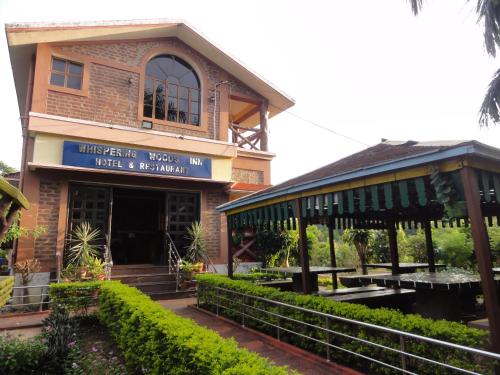 a building with a sign that reads thetis farms house with a porch at Whispering Woods Inn - Stay & Enjoy in Nature ! in Bolpur