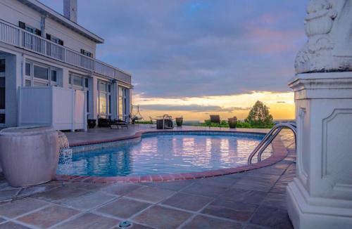 a swimming pool in front of a building at Weymouth Hall in Natchez