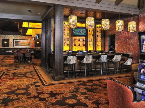 a bar in a restaurant with bar stools at L’Auberge Casino Resort Lake Charles in Lake Charles