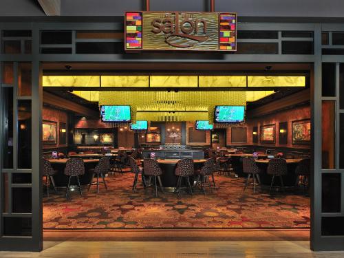 a restaurant with tables and chairs in a room at L’Auberge Casino Resort Lake Charles in Lake Charles