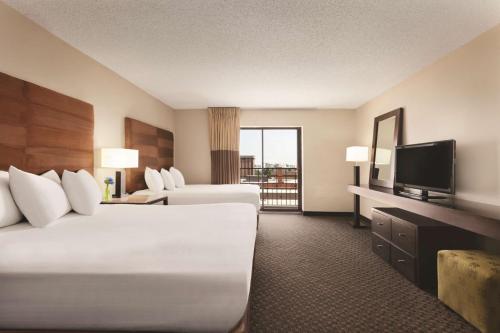 a hotel room with two beds and a flat screen tv at Hyatt Regency Green Bay in Green Bay