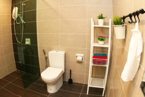 a bathroom with a toilet and a shower at CHARMING & COZY HOME @ MIDHILLS GENTING in Genting Highlands