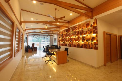 an office with a desk and chairs and a ceiling at Victory Inn Park Residency in Kunnamkulam
