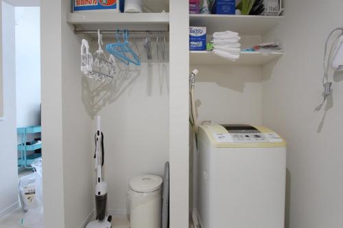 a laundry room with a washer and dryer at Shibuya Stay Tokyo A202 in Tokyo