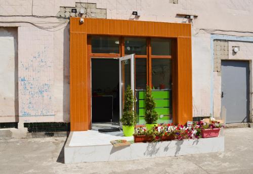 an orange building with flowers in front of it at Hostel Railway Kiev in Kyiv