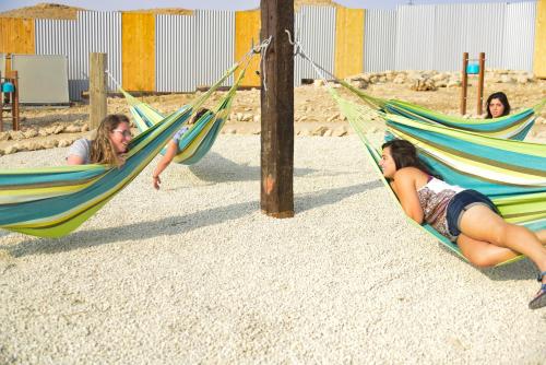 three girls laying in hammocks on a beach at Tsavta in Mashabbe Sade