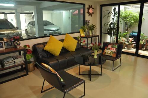 a living room filled with furniture and a couch at Double DD House at MRT Sutthisarn in Bangkok