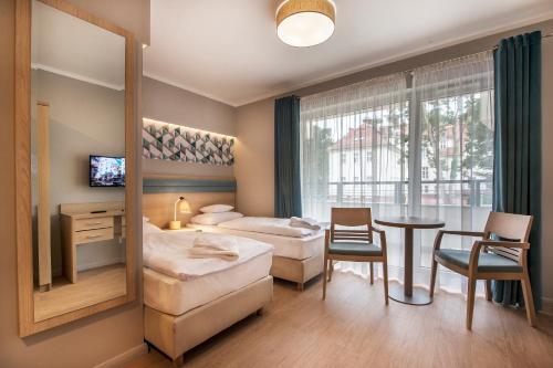 Posteľ alebo postele v izbe v ubytovaní Hotel Cesarskie Ogrody