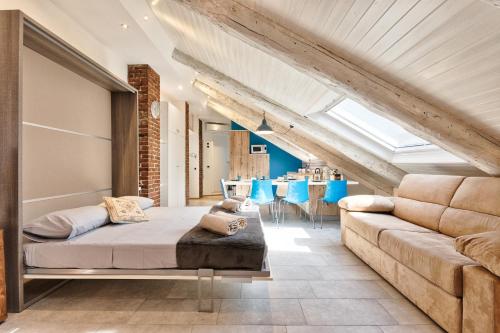 a living room with a bed and a couch at ACADAMIS - Loft dei Principini in Turin